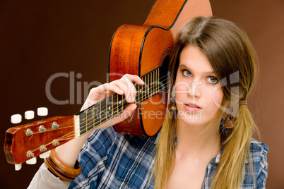 Rock musician - fashion woman holding guitar