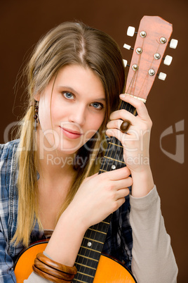 Rock musician - fashion woman holding guitar