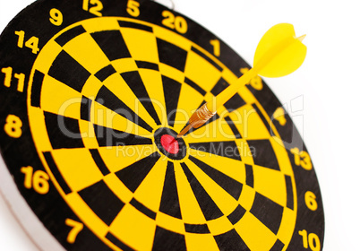 A yellow dart on a bull's-eye