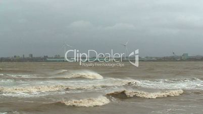 Stormy sea with wind turbines in the distance 1