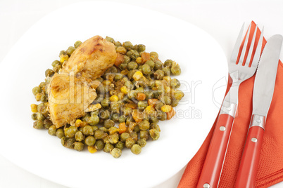 Chicken meat with green peas, carrots and corns on table Chicken meat with green peas, carrots and corns on table