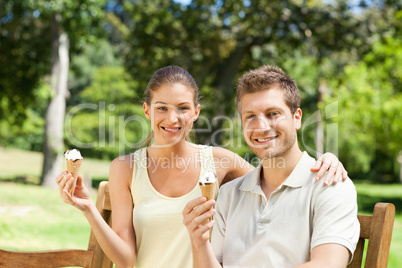 Couple eating an ice cream in the park