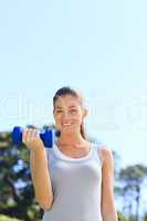 Young woman doing her exercises in the park