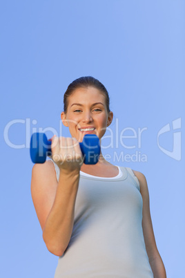 Young woman doing her exercises in the park