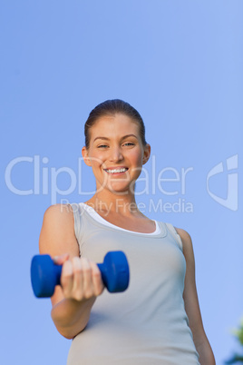 Young woman doing her exercises in the park