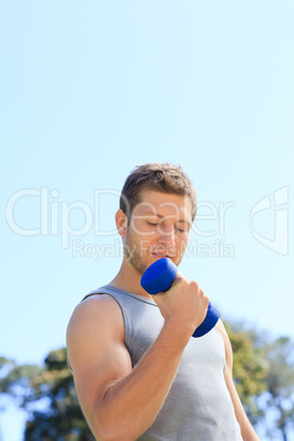 Young man doing his exercises in the park