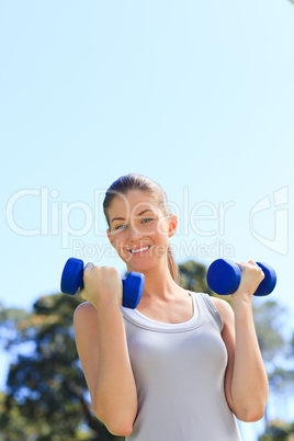 Young woman doing her exercises in the park