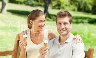 Couple eating an ice cream in the park