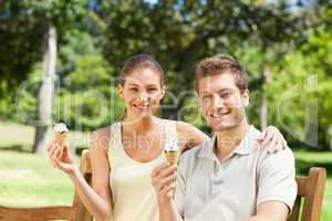 Couple eating an ice cream in the park