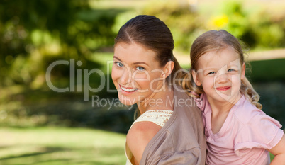 Beautiful mother giving daughter a piggyback