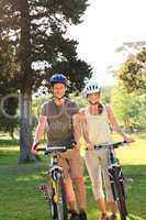 Couple with their bikes in the park