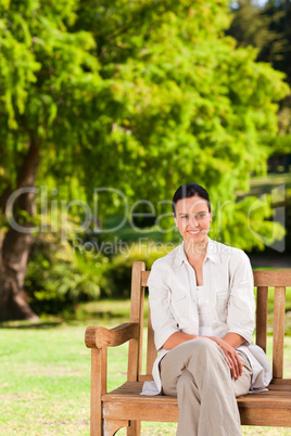 Brunette woman on the bench