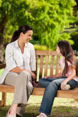 Mother and her daughter on the bench