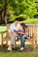 Mother and her daughter reading a book