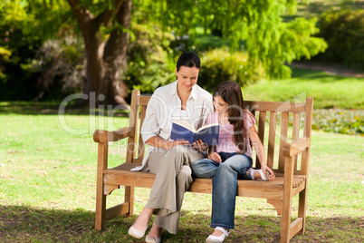 Mother and her daughter reading a book