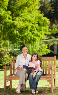 Mother and her daughter reading a book