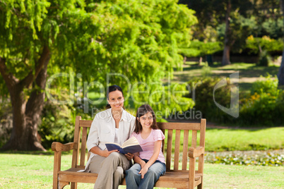 Mother and her daughter reading a book