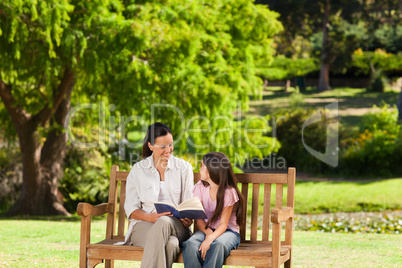 Mother and her daughter reading a book