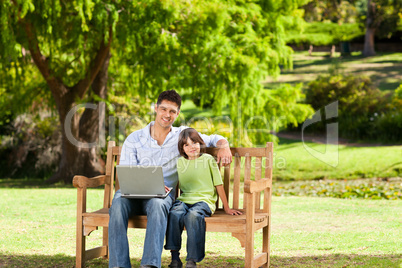 Father with his son looking at their laptop