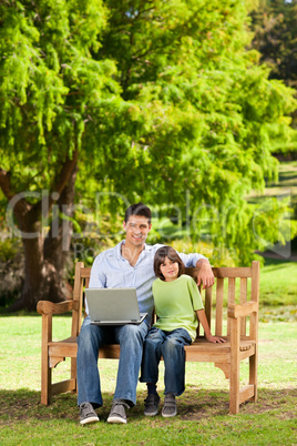 Father with his son looking at their laptop