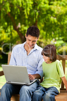 Father with his son looking at their laptop