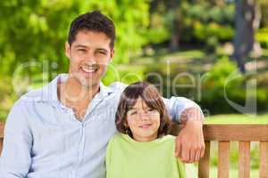 Son with his father on the bench