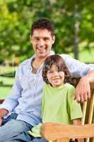 Son with his father on the bench