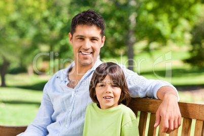 Son with his father on the bench