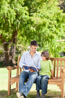 Father with his son reading a book