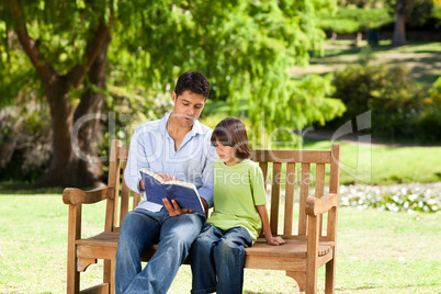 Father with his son reading a book