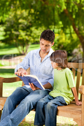 Father with his son reading a book