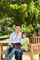 Son with his father reading a book