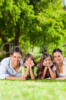 Family lying down in the park