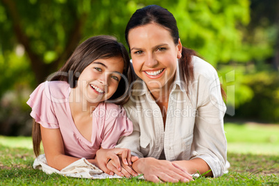 Mother with her daughter lying down