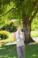 Woman drinking water after the gym