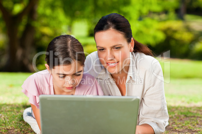 Mother and her daughter looking at their laptop