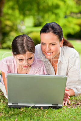 Mother and her daughter looking at their laptop