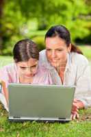 Mother and her daughter looking at their laptop