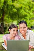 Mother and her daughter looking at their laptop