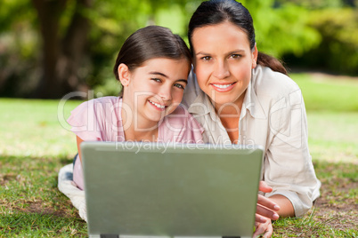 Mother and her daughter looking at their laptop