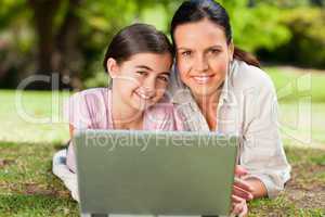 Mother and her daughter looking at their laptop