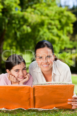 Mother and her daughter looking at their album photo