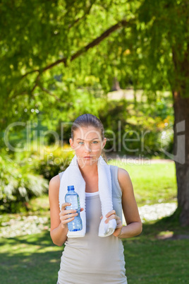 Woman drinking water after the gym