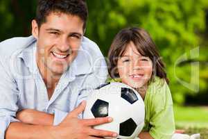 Father and his son with their ball in the park