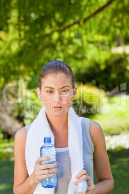 Woman drinking water after the gym