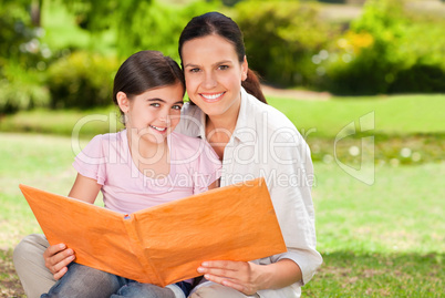 Daughter and her mother looking at their album photo