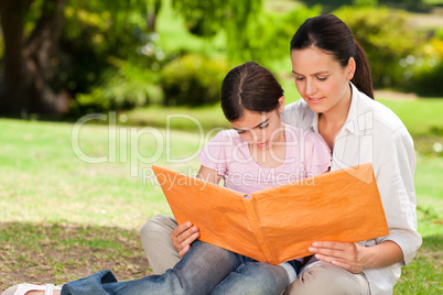 Daughter and her mother looking at their album photo