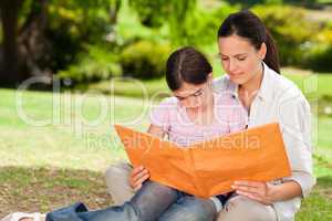 Daughter and her mother looking at their album photo