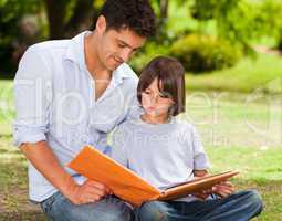 Son with his father looking at their album photo