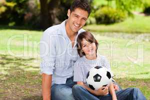 Father and his son with their ball in the park
